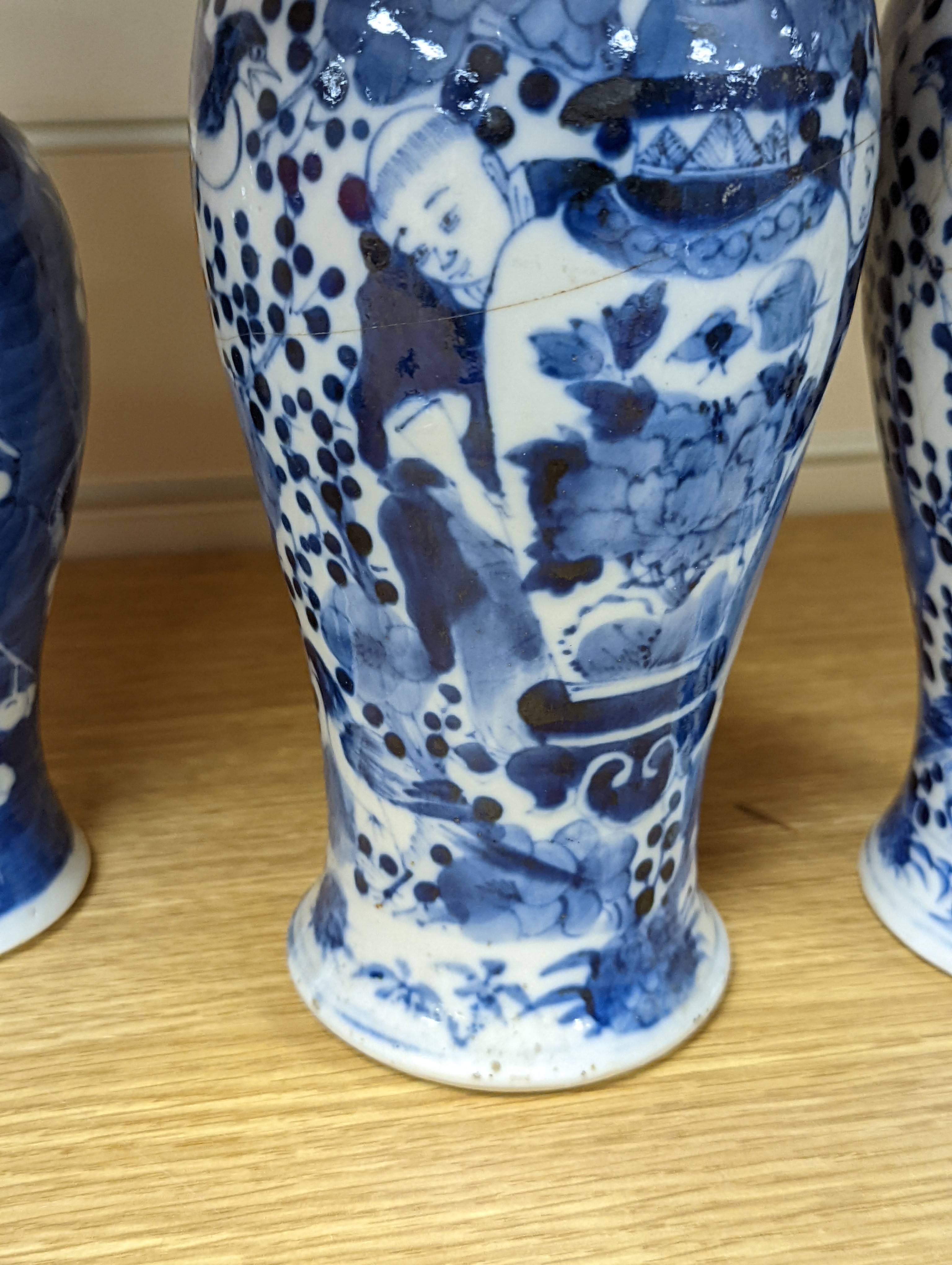A pair of 19th century Chinese blue and white vases, a prunus vase and cover and a similar jar (4), pair of vases 24 cms high.